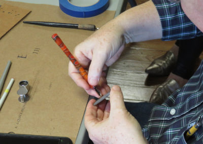 John Stevens showing how he prepares a pen for writing calligraphy