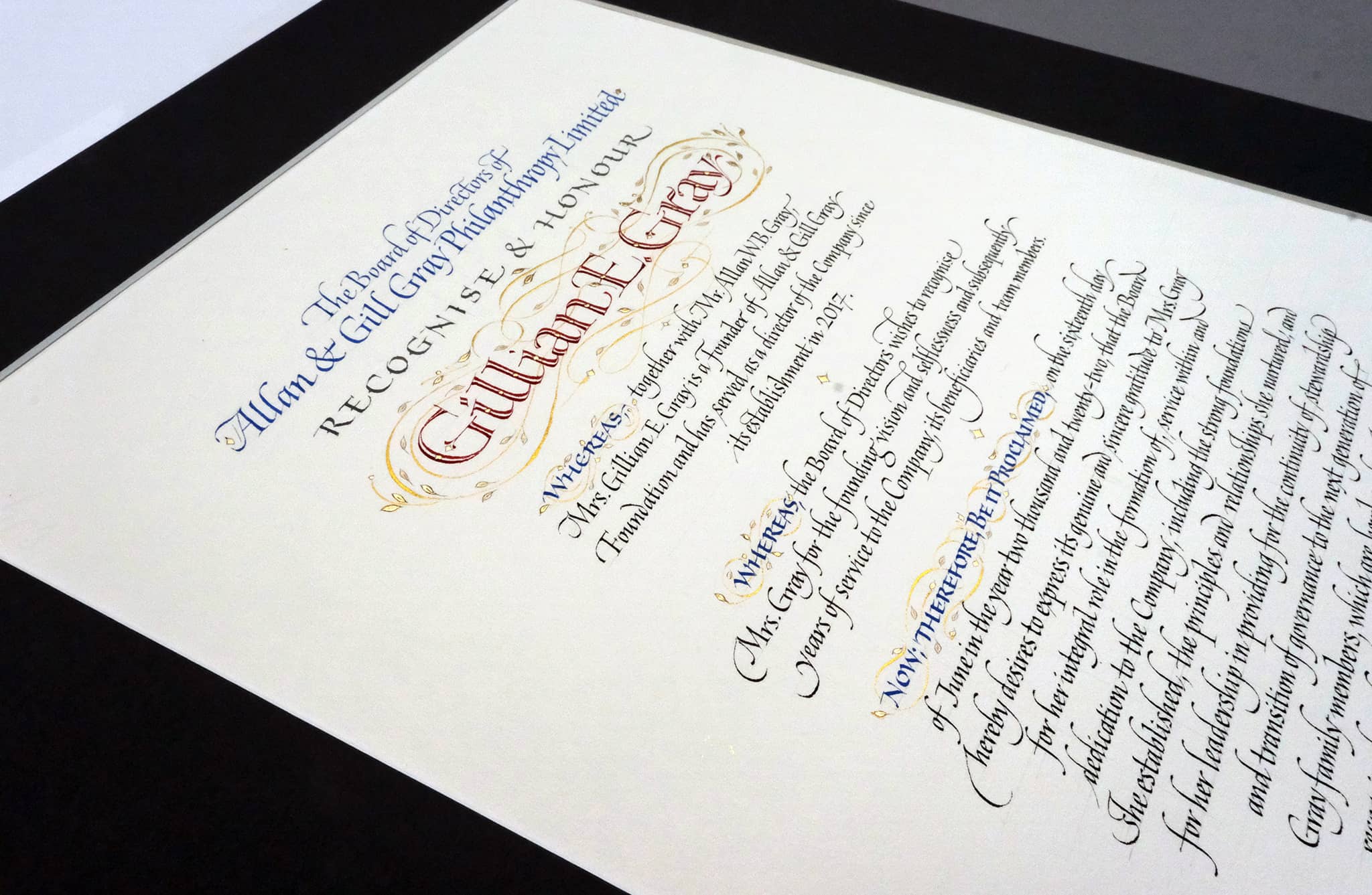 A hand-lettered Resolution that is written out and also decorated with gold leaf.